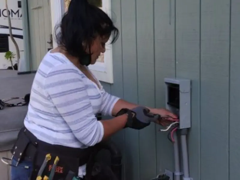 Licensed electrician wiring an exterior subpanel in Mattawan